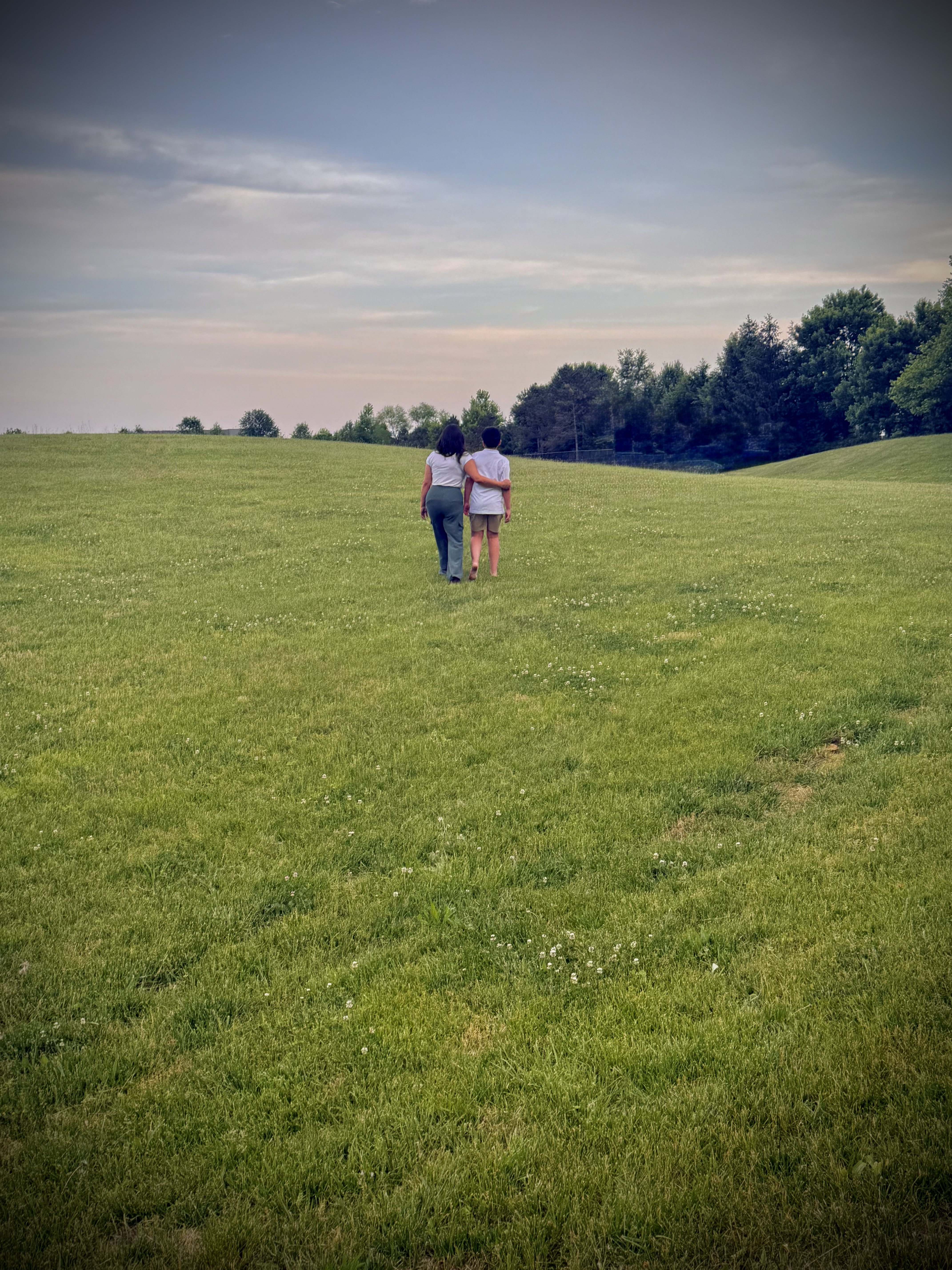 Diana and her son walking together through a field